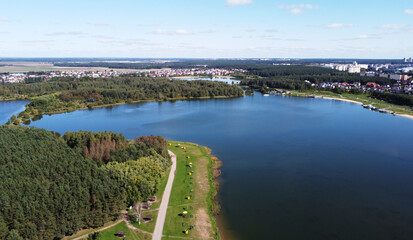 Fototapeta premium Top view of a beautiful city summer park with a lake and an embankment. 