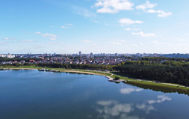 Fototapeta na wymiar Top view of a beautiful city summer park with a lake and an embankment. 