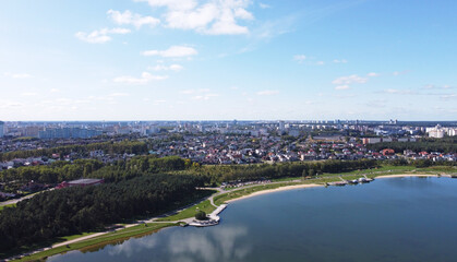 Fototapeta premium Top view of a beautiful city summer park with a lake and an embankment. 