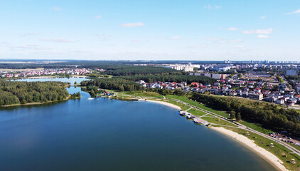 Fototapeta premium Top view of a beautiful city summer park with a lake and an embankment. 
