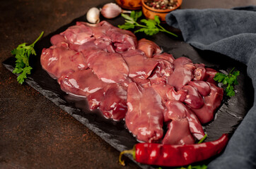 raw chicken liver on a stone background