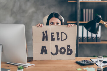 Photo of worried girl agent marketer ceo feel fear future work occupation world economics crisis situation close cover face cardboard text need job sit table in workplace workstation
