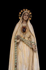 Well, Netherlands - September 30, 2020: Beautiful painted Virgin Mary statue from a catholic chapel isolated on black background