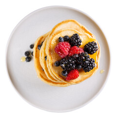 Pancakes with fresh berries and honey on gray plate isolated on white. Top view.
