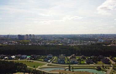 Top view of suburban area with trees and pond