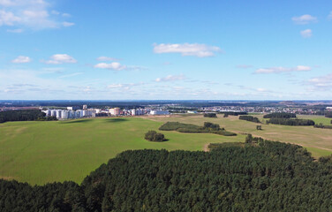 Fototapeta na wymiar Top view of a green field outside the city