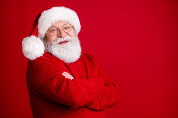 Turned photo of positive old retire pensioner man in santa claus hat cross hands enjoy fairy magic miracle advent event wear sweater isolated over bright shine color background
