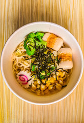 Japanese ramen in a cup on wooden table
