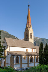 Fototapeta na wymiar Vertical view of the Stadtpfarrkirche Maria Himmelfahrt church in Landeck, Austria, on a beautiful sunny day