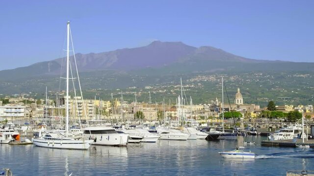 The marina of Riposto town with volcano Etna at background in Sicily