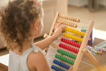 Little girl with abacus. children math education concept
