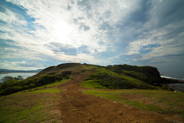 A path in the hills with a blue sky