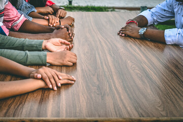 Fototapeta premium Many hands of different skin tone resting on table. Concept of equality in diversity. Concept of success in togetherness