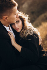 couple kissing in park autumn