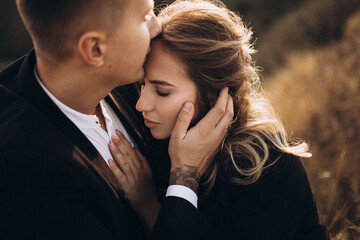 couple kissing in park autumn