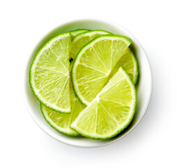Bowl of lime slices isolated on white, from above