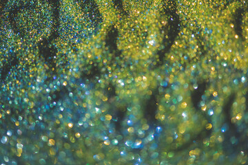 Abstract glitter lights colorful bokeh background in blue,gold and yellow color tones