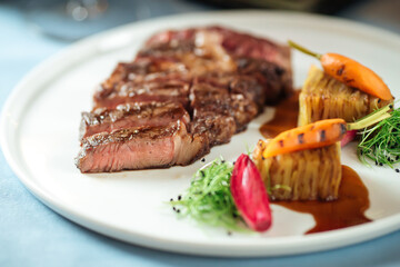 Cut grilled beef ribeye steak with potatoes