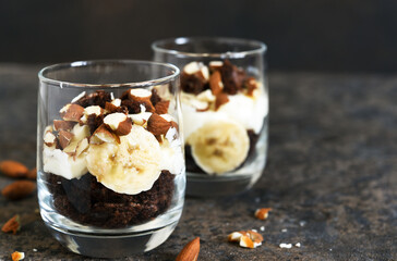 Dessert trifle with banana, chocolate biscuit and cream cheese.