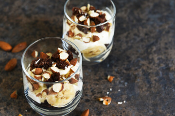 Dessert trifle with banana, chocolate biscuit and cream cheese.
