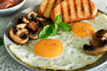 English breakfast. Fried eggs with mushrooms and ham with a glass of orange juice for breakfast. Good morning.