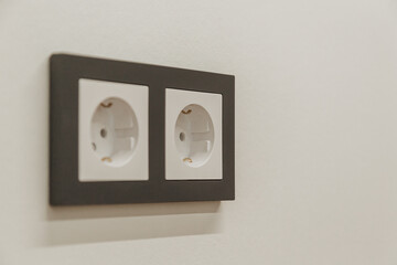 gray electrical outlet on white wall in room