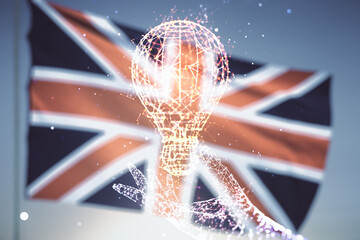 Abstract virtual light bulb hologram on flag of Great Britain and blue sky background, idea concept. Multiexposure - Powered by Adobe