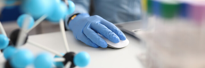 Workplace scientist with gloves working on laptop. Scientific research and development of new drugs concept