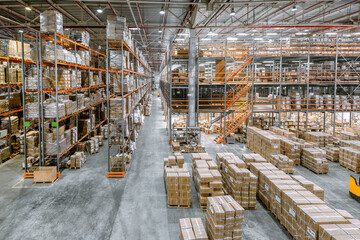 Large industrial warehouse. Tall racks are completely filled with boxes and containers. - obrazy, fototapety, plakaty