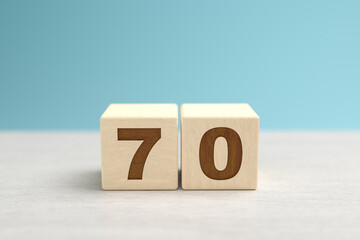 Wooden toy blocks forming the number 70.