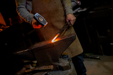 The hands of a blacksmith at work in the smithy