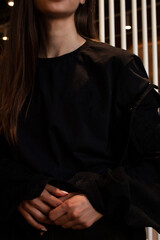 A young woman in a black t-shirt and black skirt. For a clothing brand. Mock up.