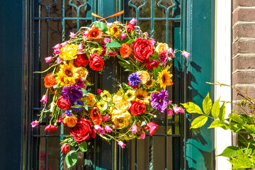 Fototapeta premium Arrangement of colorful flowers on a front door.