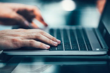 close up. modern man typing on a laptop keyboard.