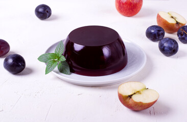 Berry jelly on the ceramic plate on the white table