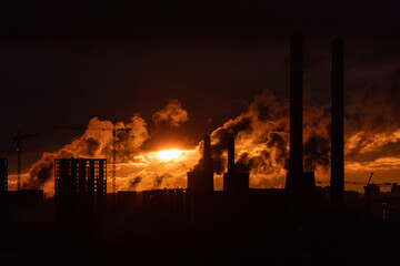Fototapeta na wymiar Steam from the power plant at sunrise
