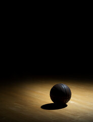 Basketball On Hardwood Court Floor With Spot Lighting. Workout online concept. Long web banner copy space