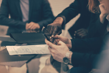 Fototapeta premium close up. business colleagues viewing messages on a smartphone