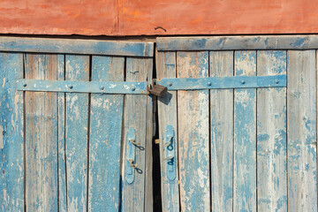 The old wooden barn doors are locked.