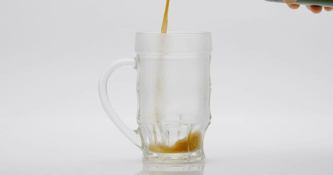 Beer Poured Into A Glass On A White Background