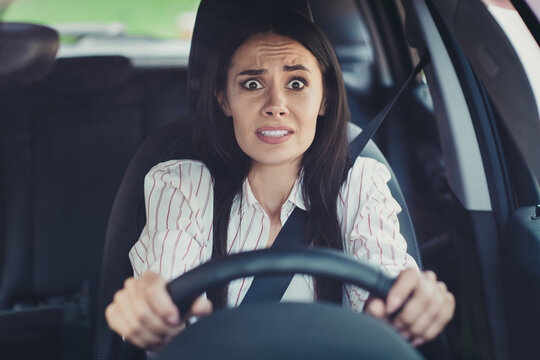 Close-up portrait of her she nice-looking attractive lovely brunette scared emotional girl riding new car early morning traffic jam bad skills lack of experience