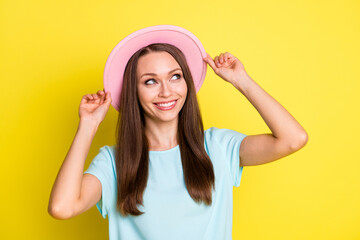 Obraz na płótnie Canvas Photo of cute nice girl tourist look up copyspace touch her sunhat enjoy summer holiday wear casual season style clothes isolated over vibrant color background