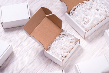 Shredded paper filler in cardboard box on wooden table