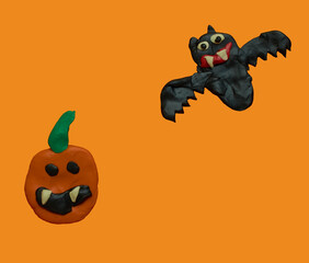 Children's crafts made of plasticine. Halloween. Bat and pumpkin