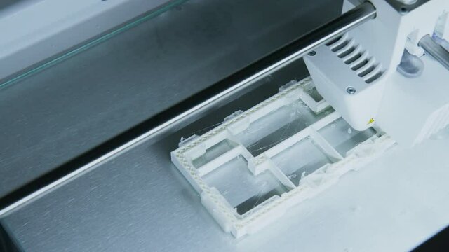 Camera Pan Across 3d Printer Printing Plastic Building Model in Architects Office