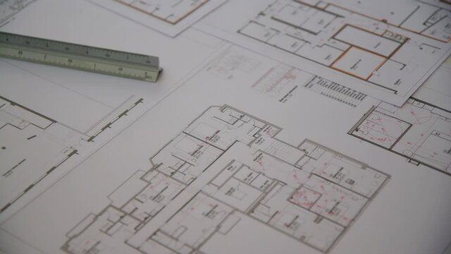 Building Blueprints and a ruler Lay out on an architects desk during the day