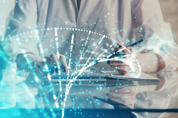 DNA theme hologram over woman's hands writing background. Concept of education. Double exposure
