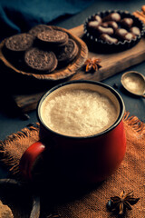 Red mug of black coffee with milk close up