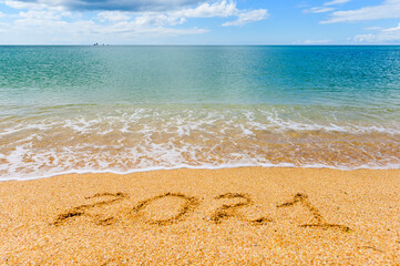 Seashore on a sunny day. Beach Caption 2021. Focusing on the water in the center of the frame.