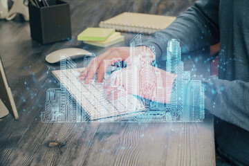 High tech city drawing with businessman working on computer on background. Smartcity concept. Double exposure.